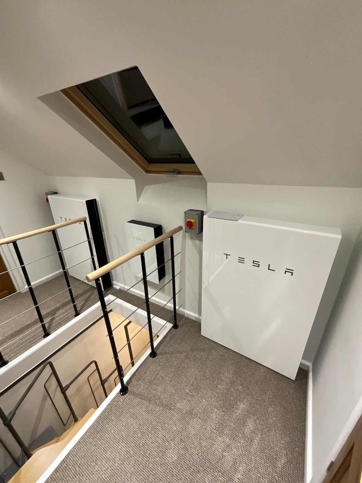 Two Tesla Powerwall batteries beside the staircase in Chelmont
